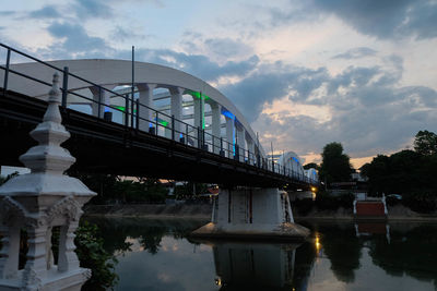 Arch bridge over river against sky