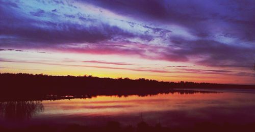 Scenic view of lake against romantic sky at sunset