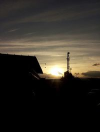 Silhouette buildings against sky during sunset