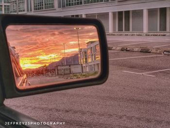 Car on road against sky at sunset