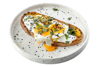 Close-up of food in plate against white background