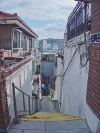View of alley amidst buildings in city