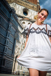 Portrait of a beautiful young woman in city