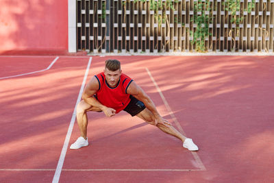 Full length of boy playing tennis