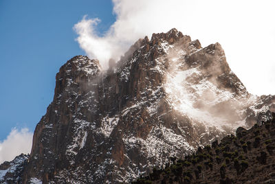 Low angle view of rock formation against sky