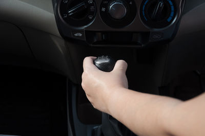 Driver hand shifting the gear stick,hand on car gear knob.the driver switches the speed in the car.