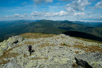 Rear view of people on mountain against sky