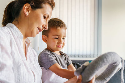 Mother and son making craft decoration at home