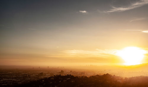 Aerial view of buildings against sky during sunset