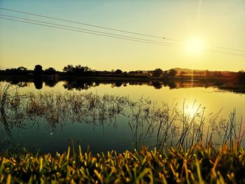 Scenic view of lake against sky during sunset