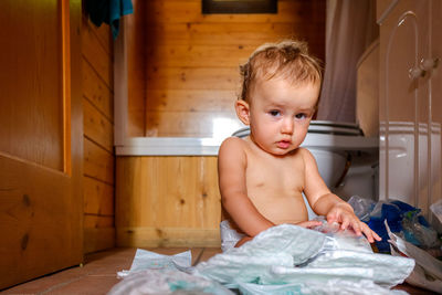 Portrait of cute baby girl with diapers at home