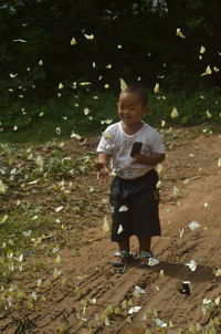 Full length of boy standing on ground