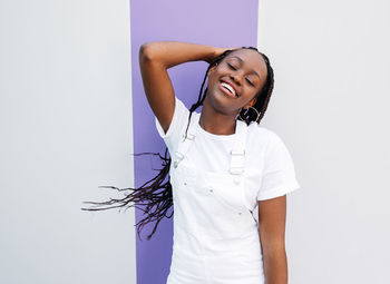 Young woman standing against white background