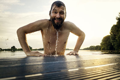 Man getting out of water on jetty