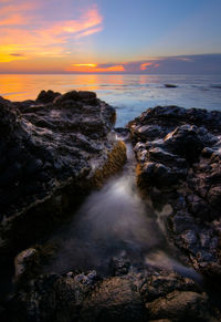 Scenic view of sea against sky during sunset