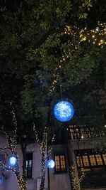 Low angle view of illuminated christmas tree at night