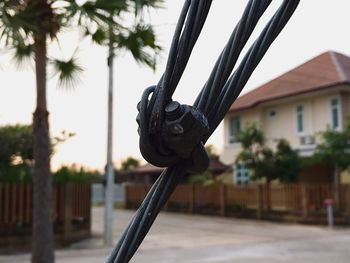 Close-up of metallic structure against sky