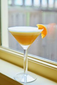 Cocktail with tangerine by window