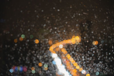 High angle view of wet illuminated street during rainy season