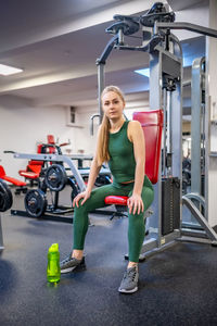 Young woman exercising in gym