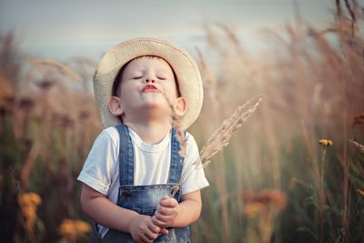 Cute boy holding crop