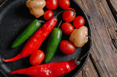 High angle view of tomatoes and vegetables on table