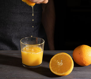 Close-up of orange juice in glass on table