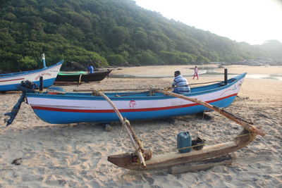 Boats moored on shore at beach