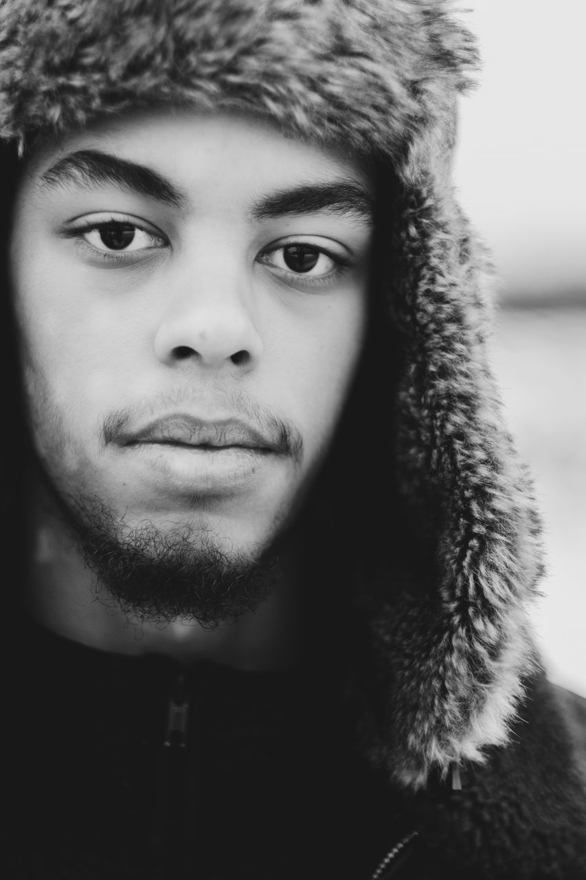 CLOSE-UP PORTRAIT OF YOUNG MAN WITH SNOW