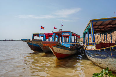 Boat moored on sea against sky