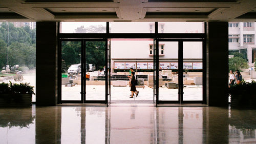 Reflection of people on glass window