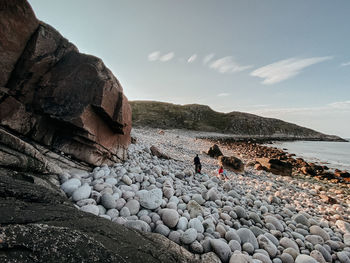 Rocks on beach against sky