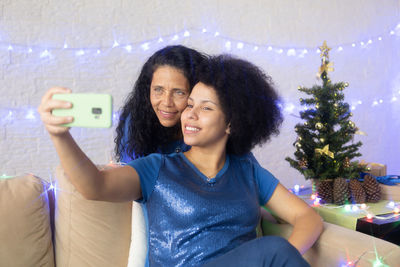 Portrait of a smiling young woman using smart phone