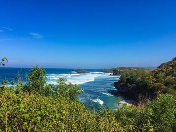 Scenic view of sea against clear blue sky