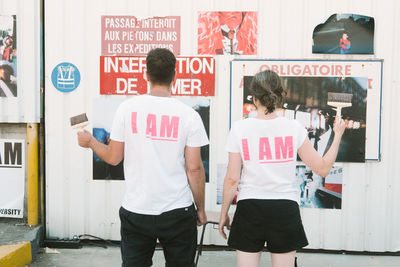 Rear view of men standing on street