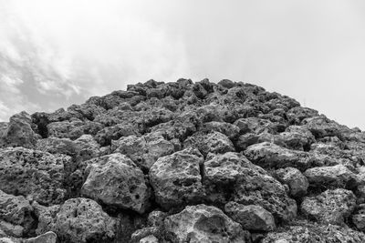 Low angle view of rock formation against sky