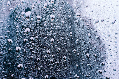 Full frame shot of wet glass window in rainy season