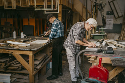 Senior craftsmen working together at carpentry workshop
