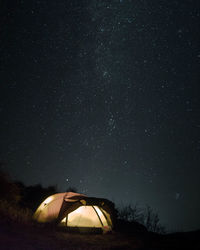 Tent on field against sky at night