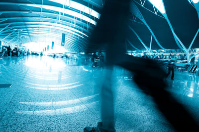 Blurred motion of illuminated lights on tiled floor in city