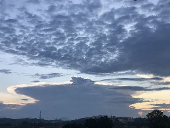 Low angle view of dramatic sky over city