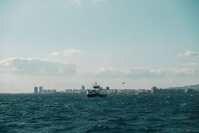 Ship sailing in sea against sky