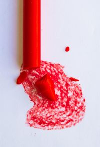 Close-up of red chili over white background