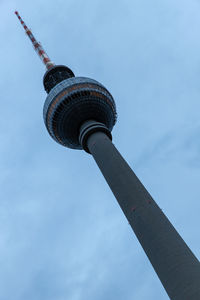 Low angle view of communications tower against sky