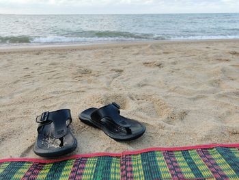 High angle view of shoes on sand at beach