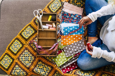 Low section of woman sitting at home