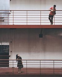 Man standing on railing