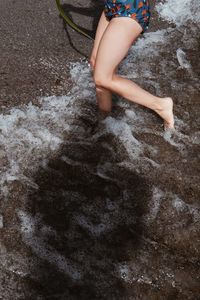 Low section of woman legs in water