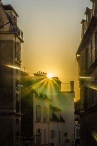 Low angle view of buildings against sky during sunset