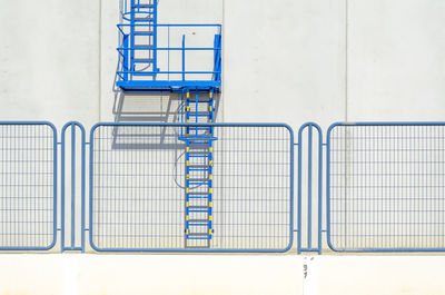 Close-up of railing against blue wall